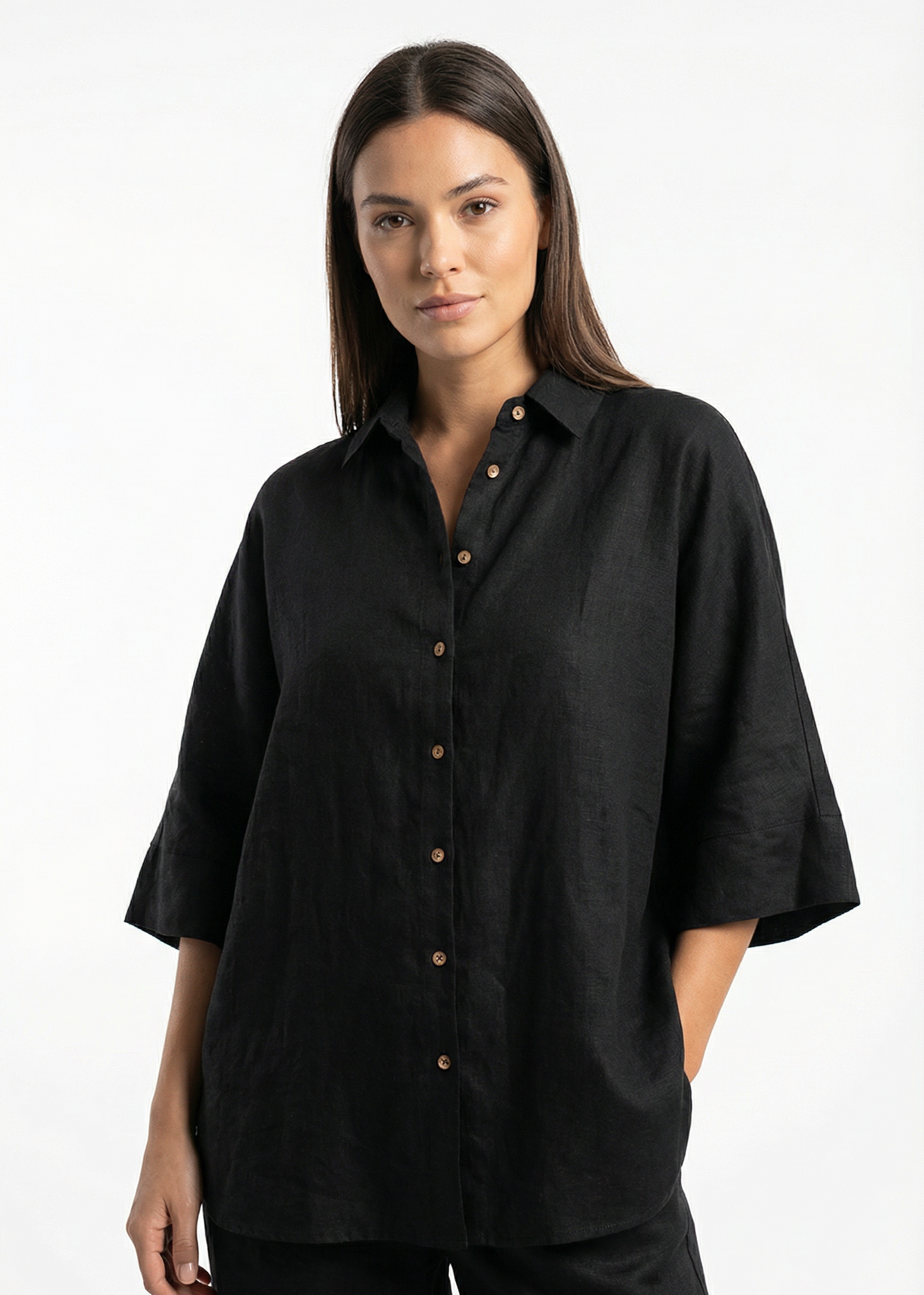 Woman wearing a black shirt with short sleeves on a white background