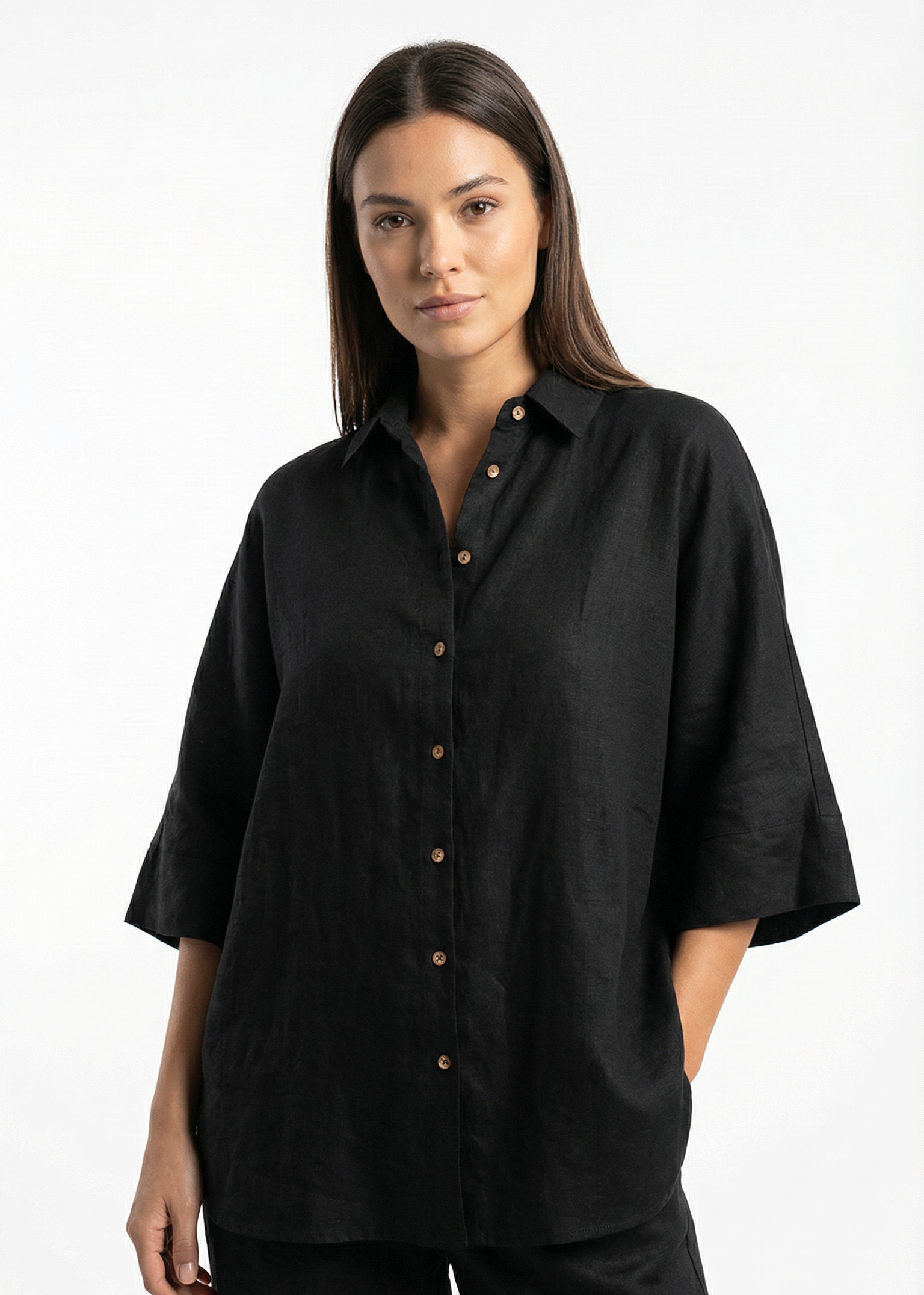 Woman wearing a black shirt with short sleeves on a white background