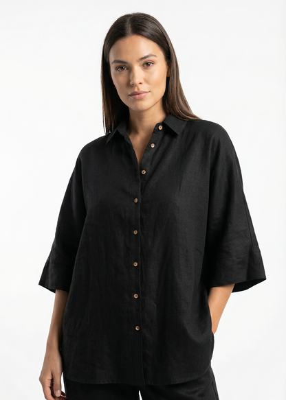 Woman wearing a black shirt with short sleeves on a white background