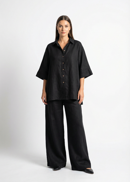 Woman wearing a black outfit on a white background