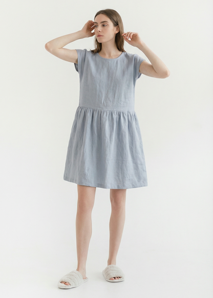 Woman wearing a light blue dress on a white background