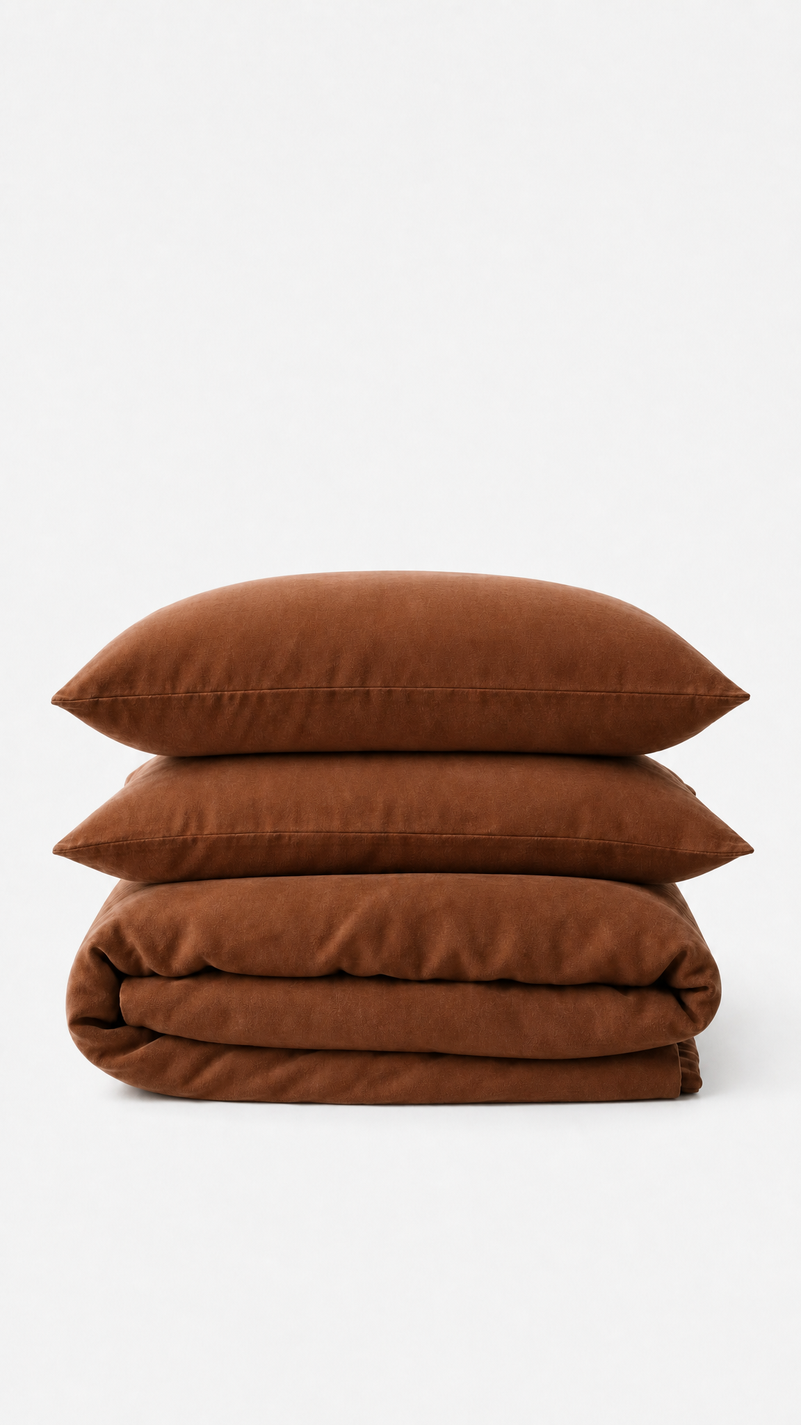 Stack of brown pillows and a folded brown blanket on a white background