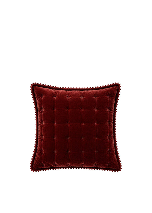 A square deep burgundy velvet throw pillow with a buttoned tufted center and a decorative beaded edge, shown against a plain white background.