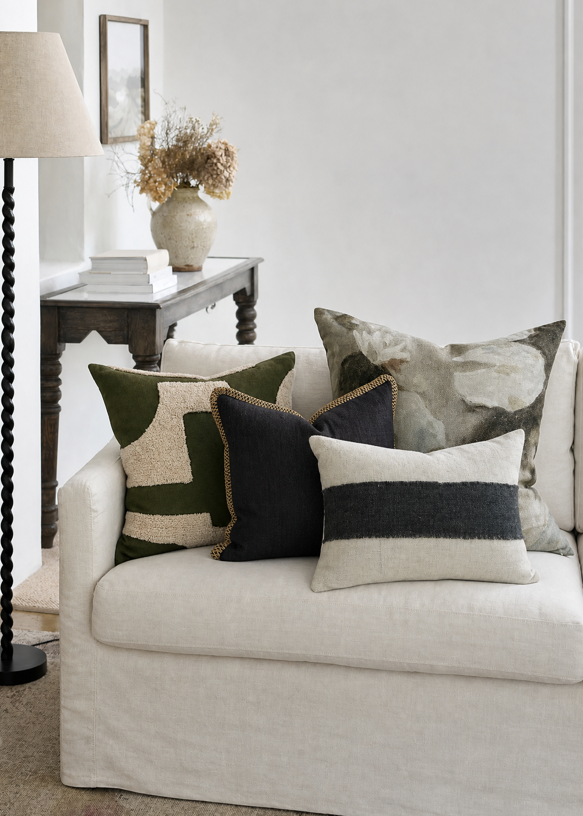 White sofa with patterned cushions in a living room setting