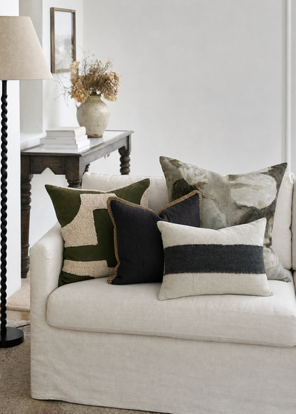 White sofa with patterned cushions in a living room setting
