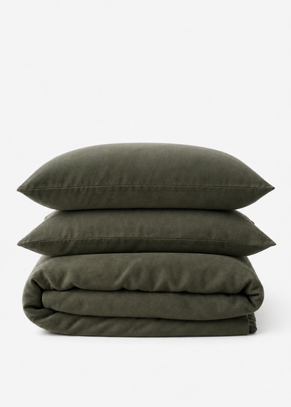 Stack of green bedding on a white background