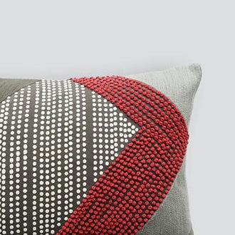 Decorative pillow with geometric pattern on a light gray background