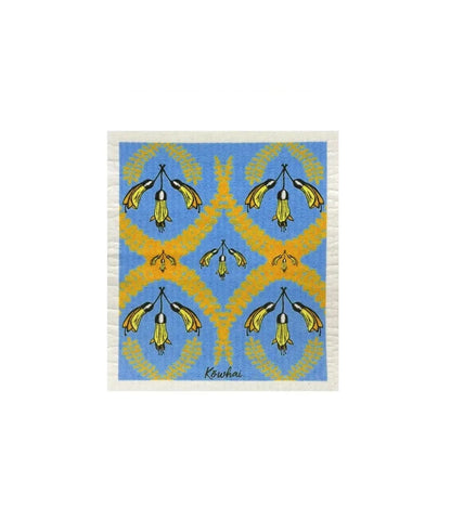 A dish cloth with a blue background and yellow and white floral patterns.
