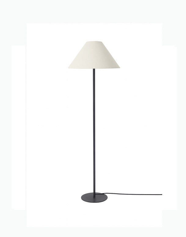 Floor lamp with a white shade and black base on a white background