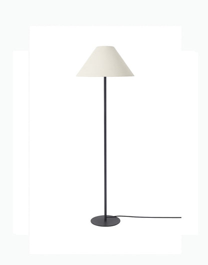 Floor lamp with a white shade and black base on a white background