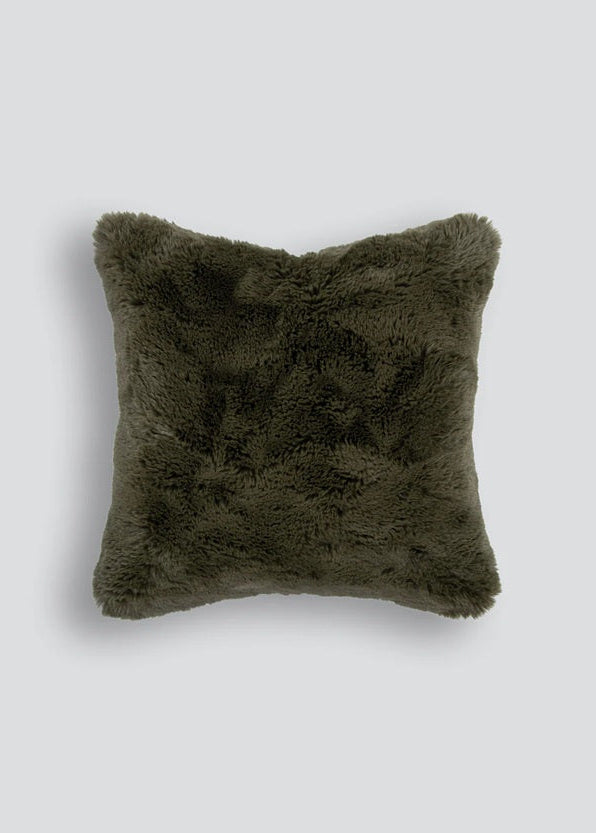 Green fluffy pillow on a light gray background