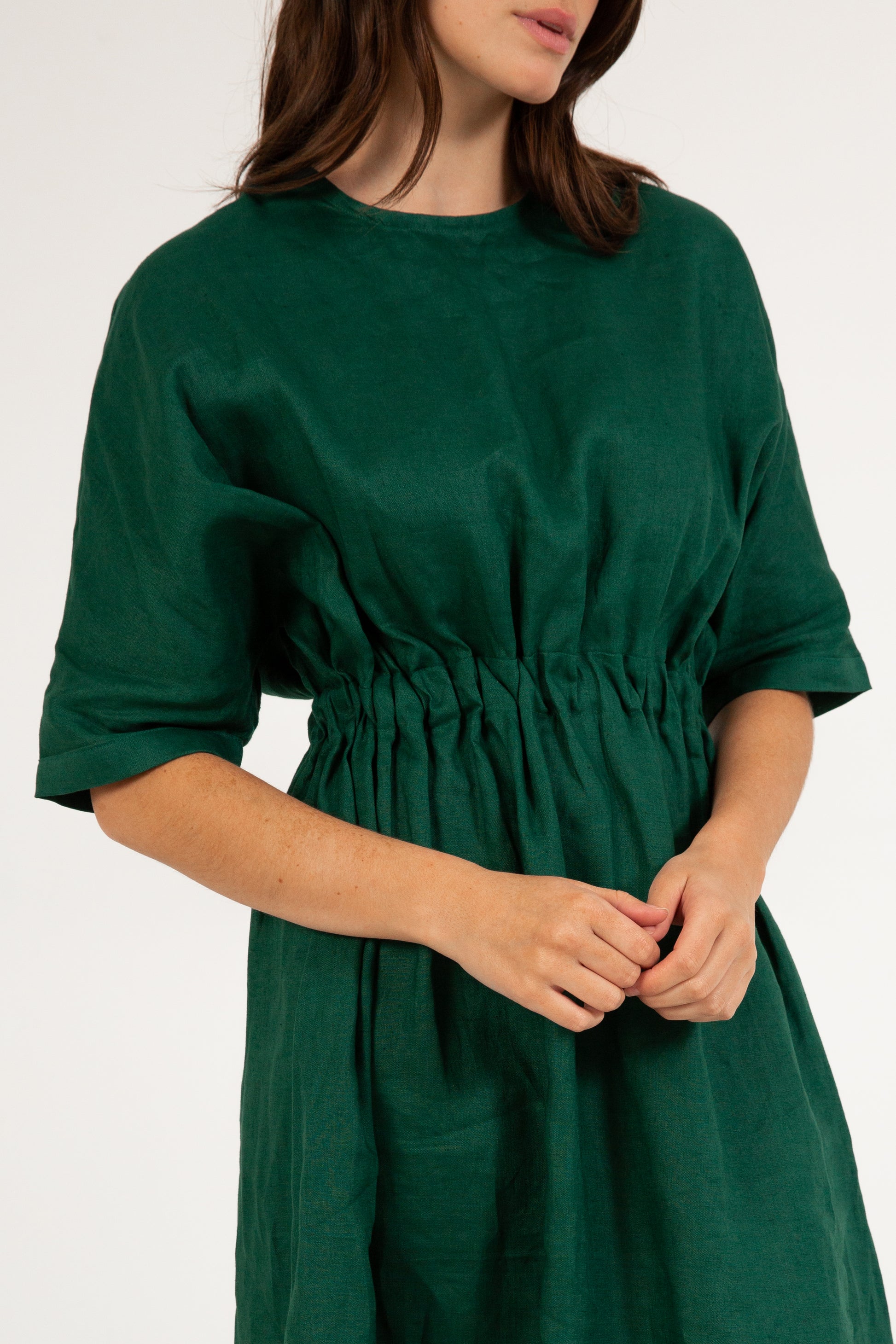 Green dress worn by a person on a white background