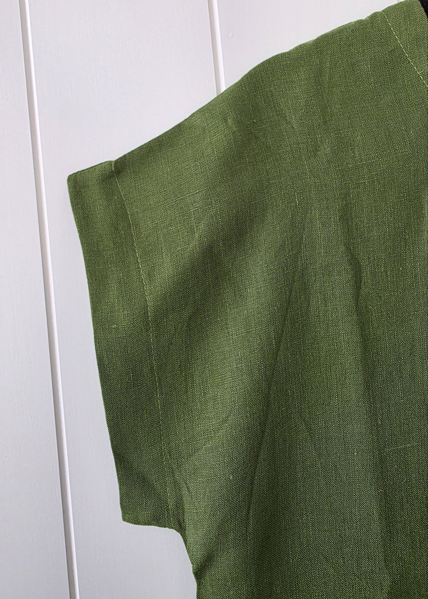 Green fabric draped over a white surface