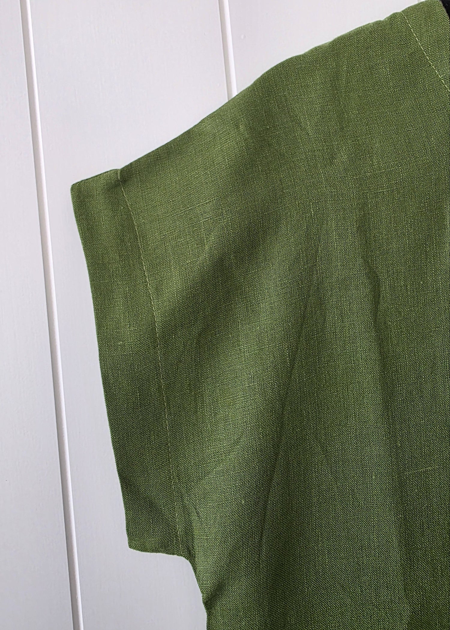 Green fabric draped over a white surface
