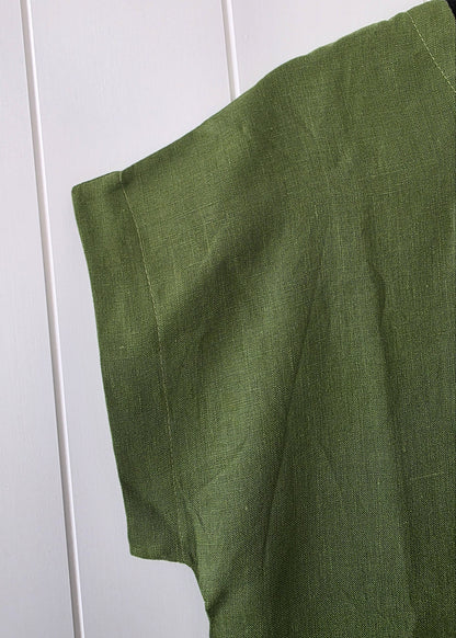 Green fabric draped over a white surface