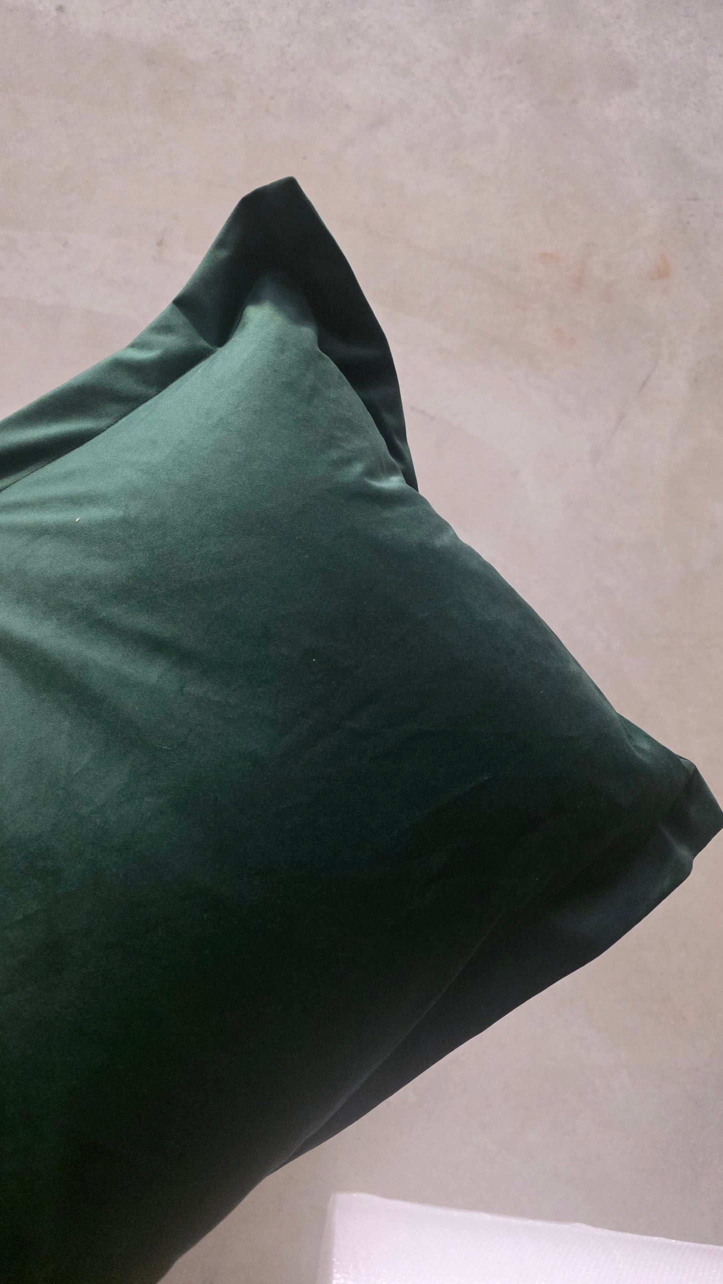 Green pillow on a neutral background