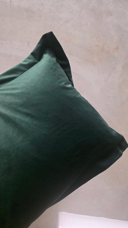 Green pillow on a neutral background
