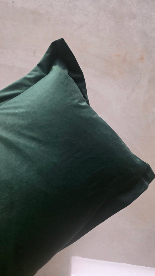 Green pillow on a neutral background