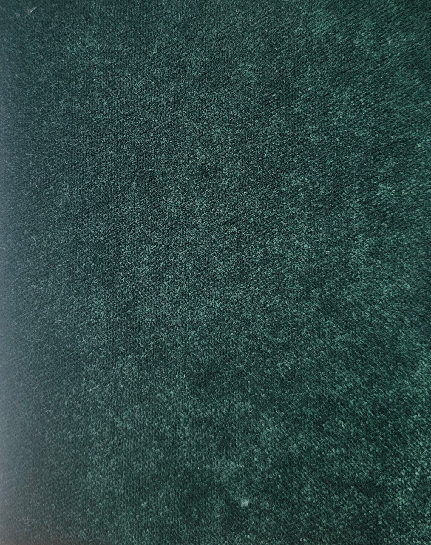 Close-up of a textured green fabric surface