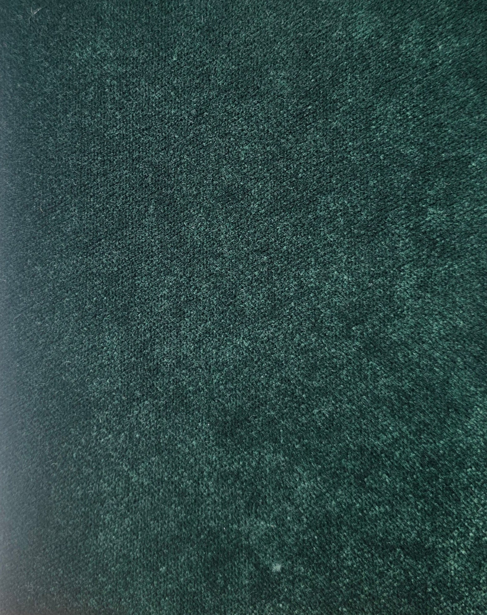 Close-up of a textured green fabric surface