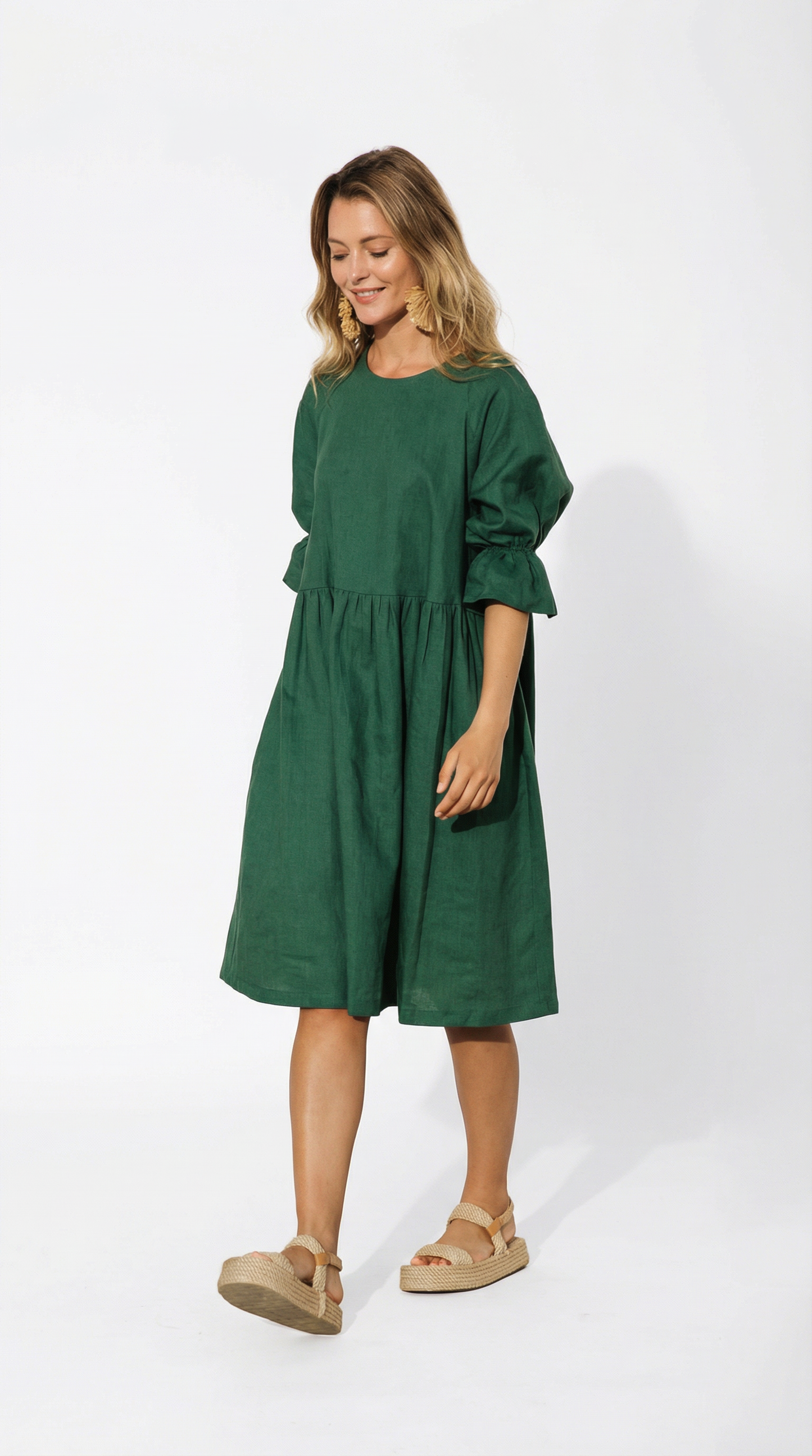 Woman wearing a green dress on a white background