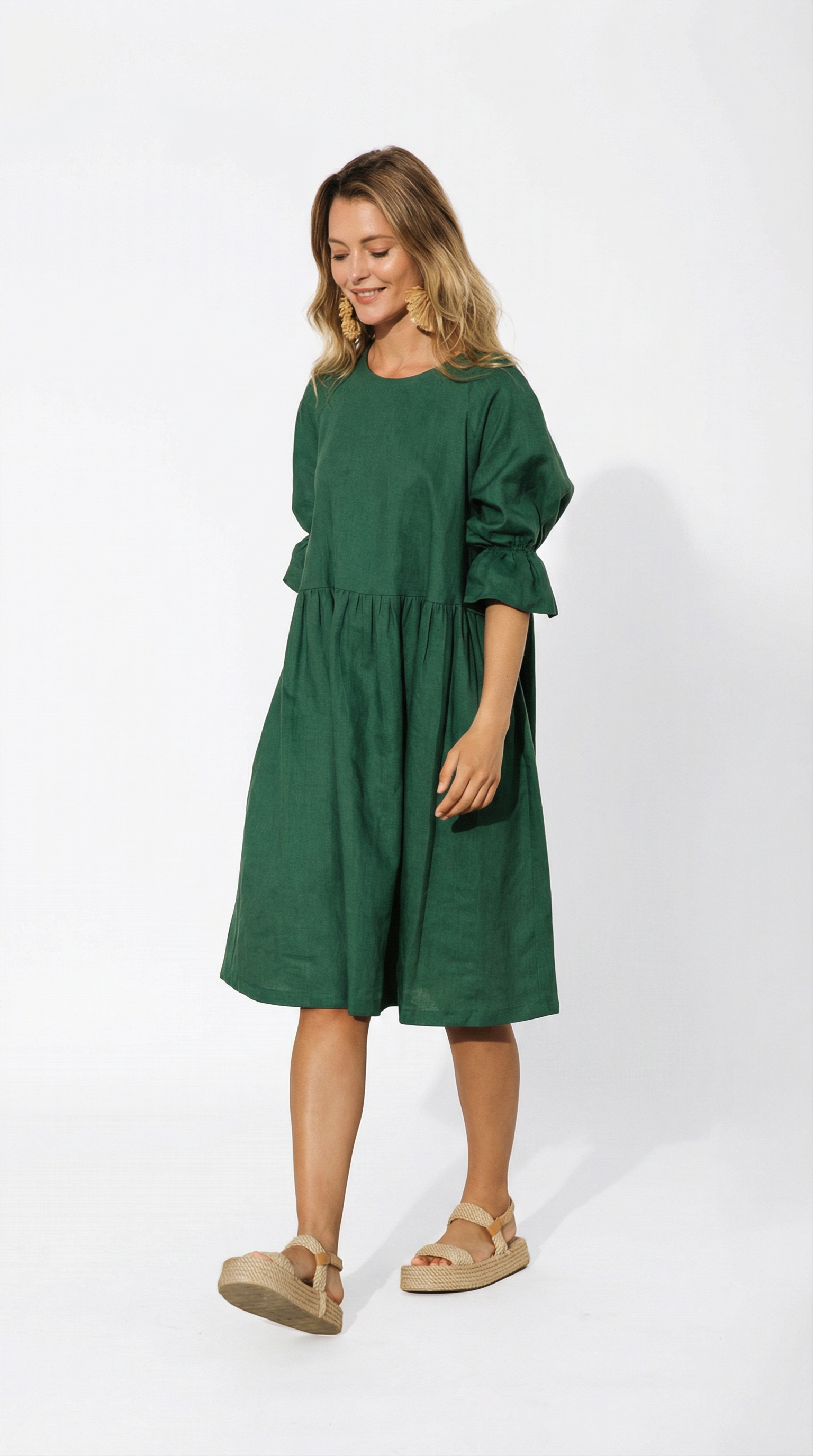 Woman wearing a green dress on a white background