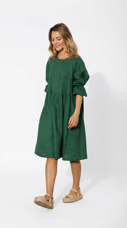 Woman wearing a green dress on a white background