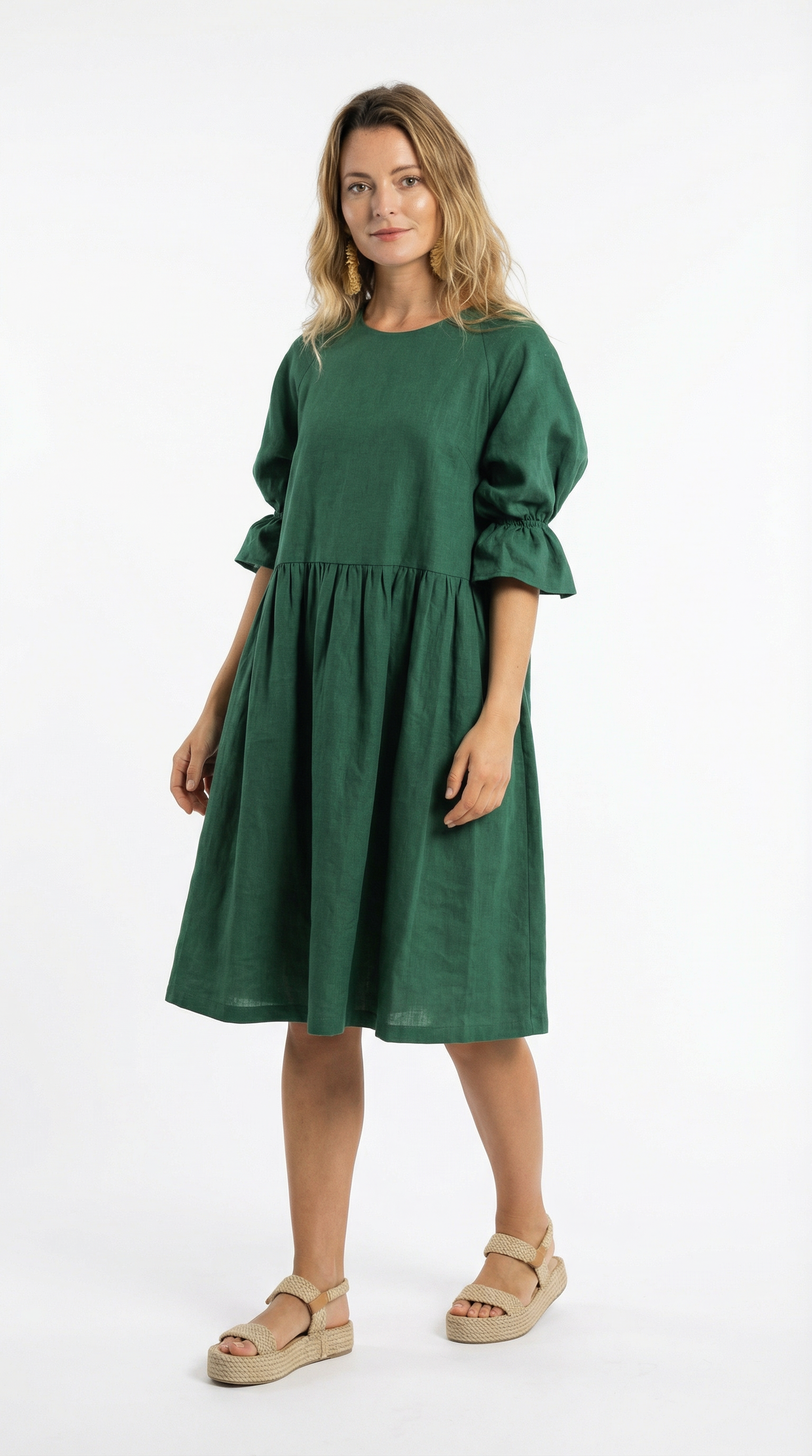 Woman wearing a green dress on a white background