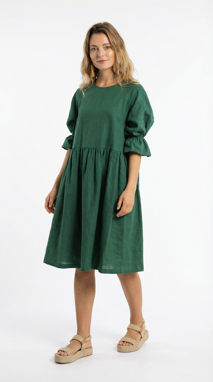 Woman wearing a green dress on a white background