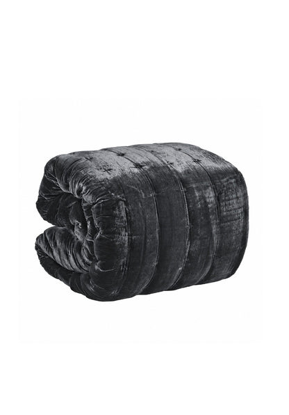 A rolled black velvet quilt or comforter with a tufted button design, shown on a plain white background.