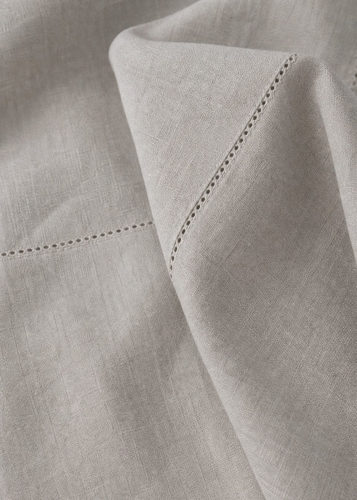 Close-up of light gray fabric with a subtle pattern