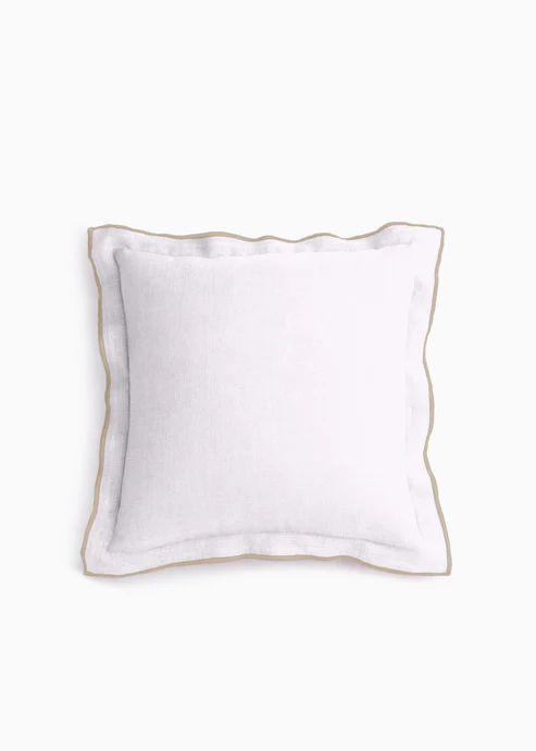 White pillow with gold trim on a white background