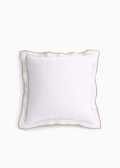 White pillow with gold trim on a white background