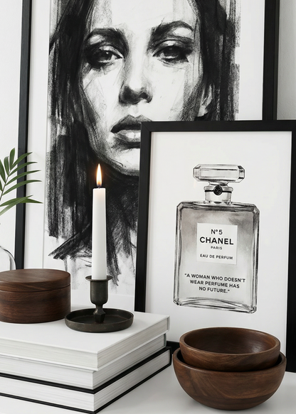 Framed black and white portrait and Chanel perfume bottle art on a shelf with decorative items.