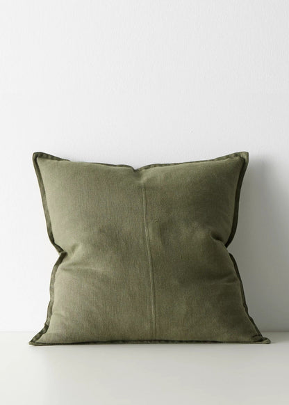 An olive green throw pillow with a matching piped edge, centered against a plain white background.