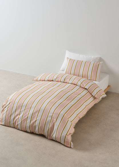 Striped bedding set on a bed with a plain background