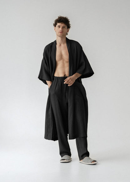 Man wearing a black robe on a white background