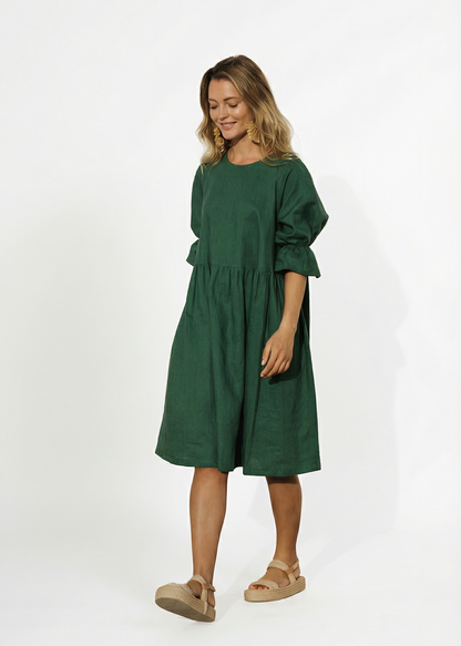 Woman wearing a green dress on a white background