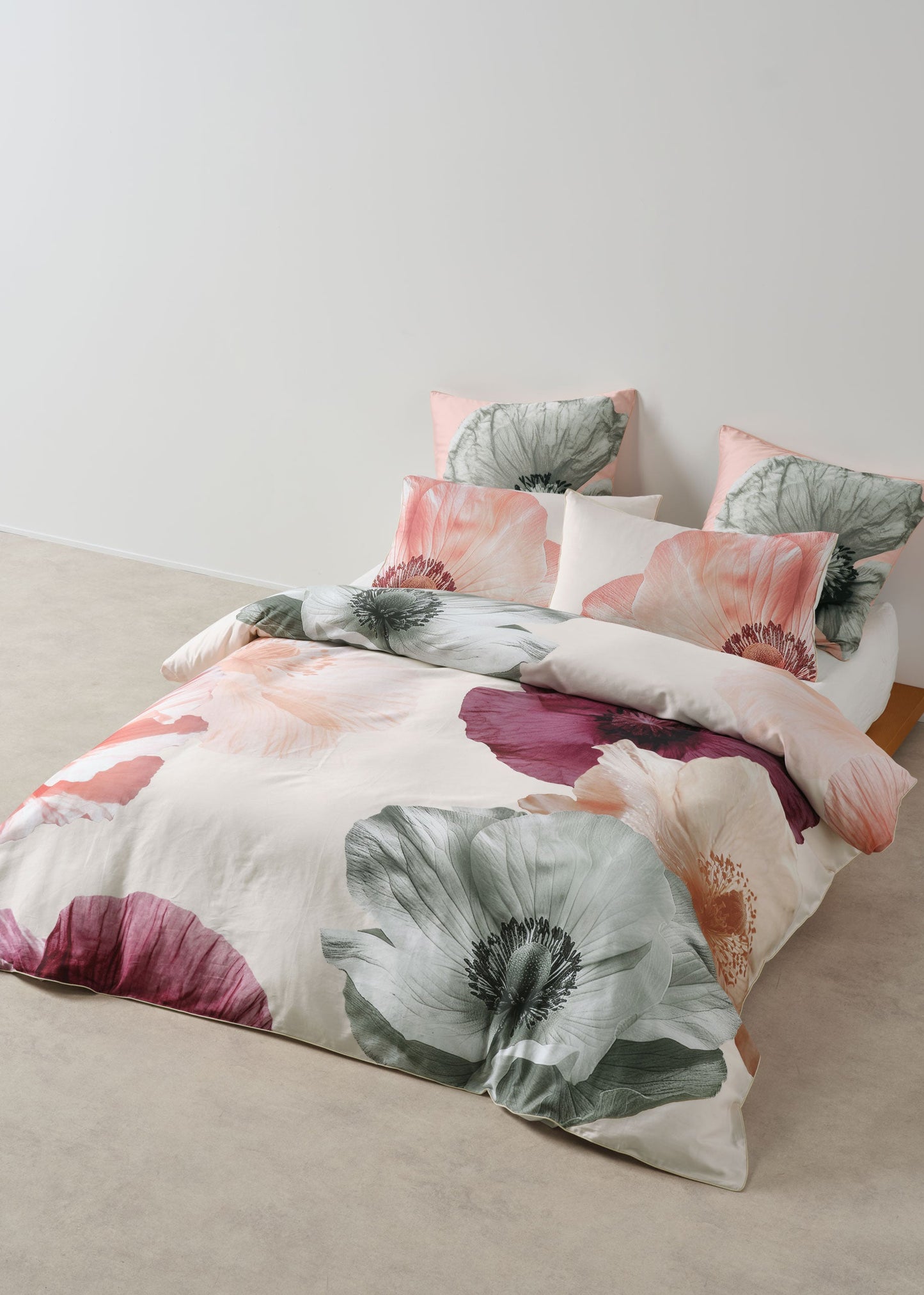 Floral bedding set on a bed with a neutral background