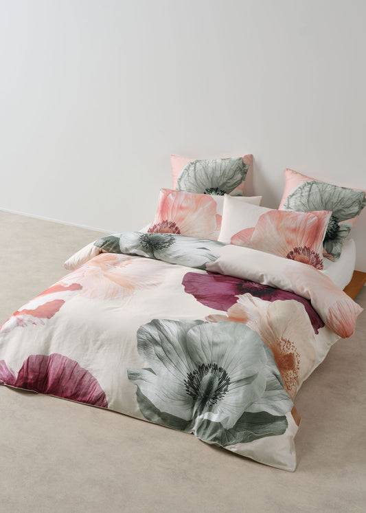 Floral bedding set on a bed with a neutral background