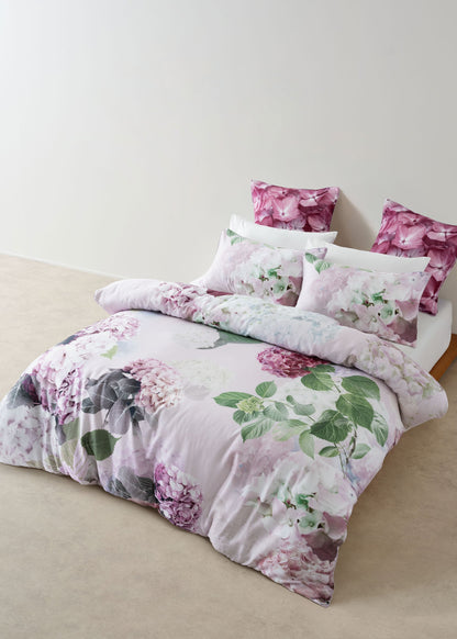Floral bedding set on a bed with a light background