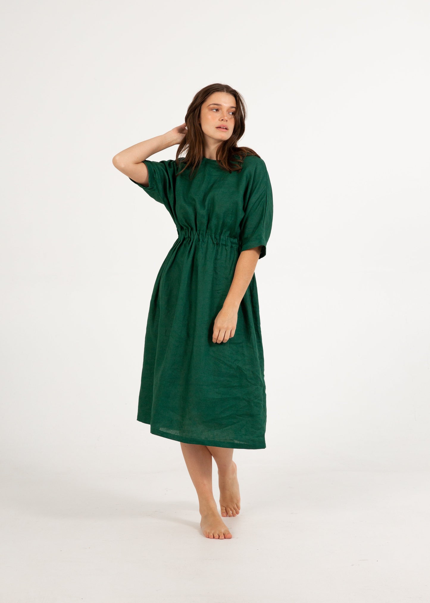 Woman wearing a green dress on a white background