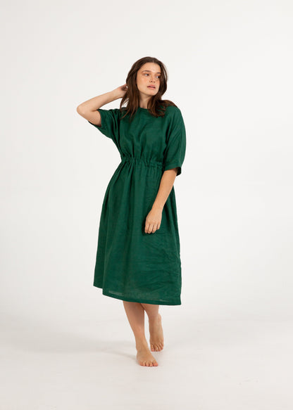 Woman wearing a green dress on a white background