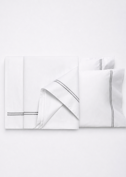 White bedding set with subtle gray stripes on a white background
