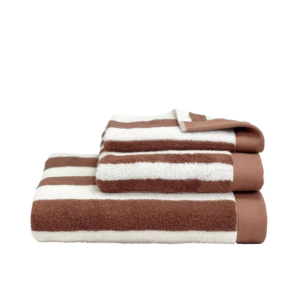 A set of three folded striped towels in brown and off-white, arranged in a stack on a plain white background.