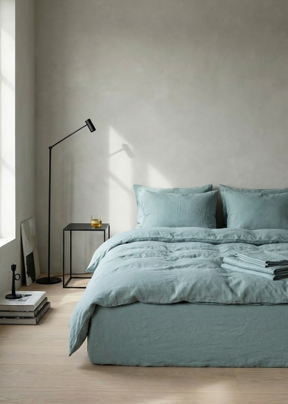 Modern bedroom with light blue bedding and minimal decor.
