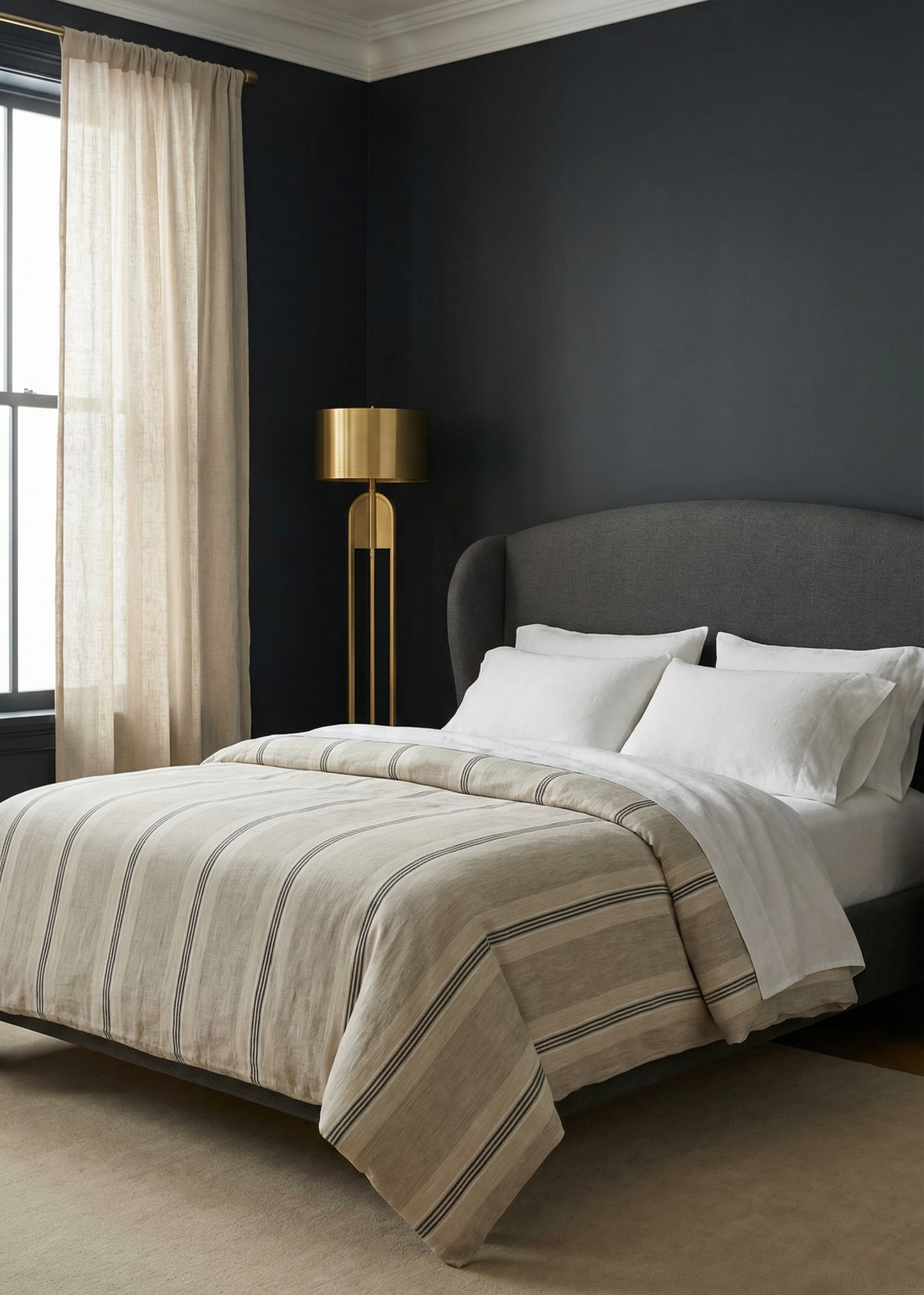 Modern bedroom with dark walls, a bed with striped bedding, and a standing lamp.