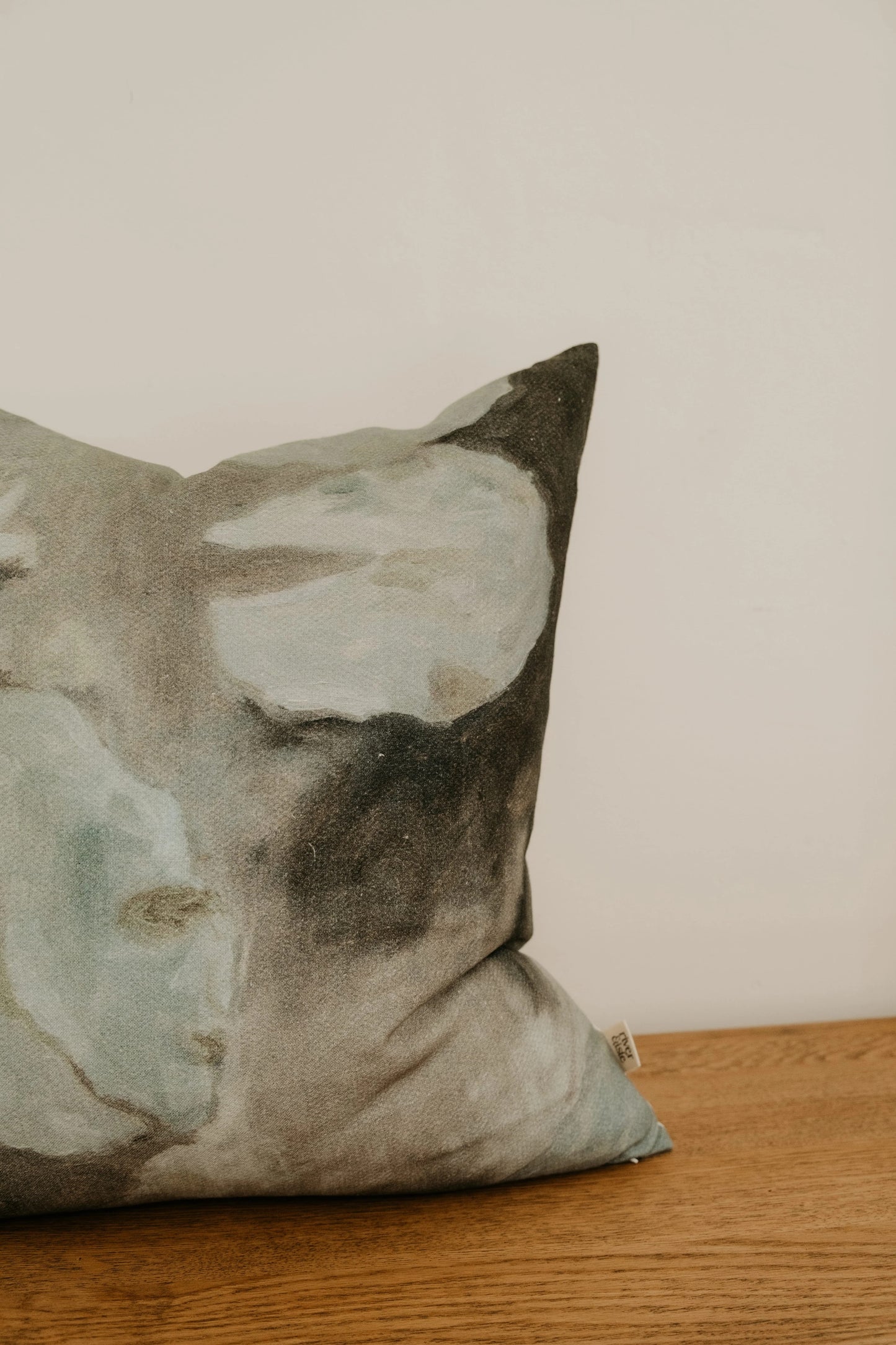 Decorative pillow with abstract design on a wooden surface
