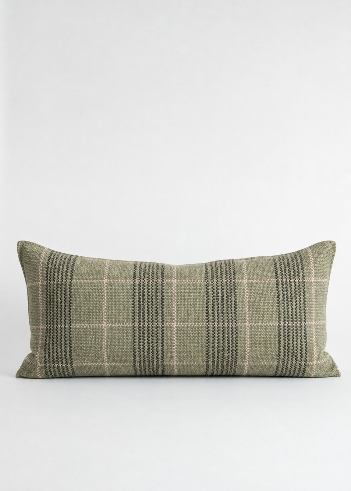 Green plaid pillow on a white background