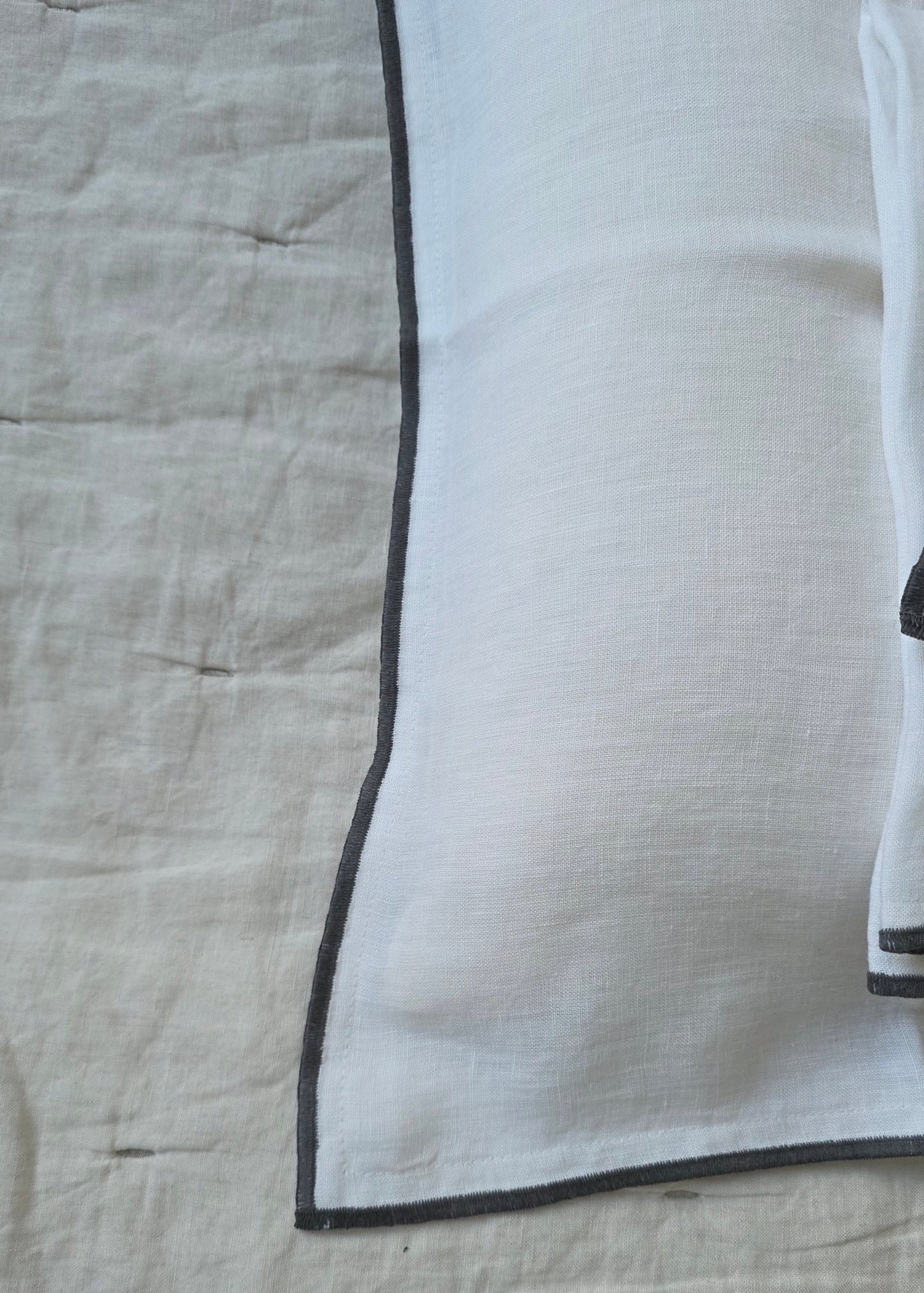 Textured fabric with a black border on a beige background